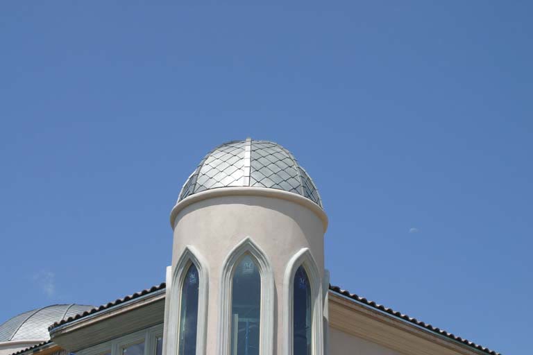 Standing-seam dome roof over a gothic-arched window turret