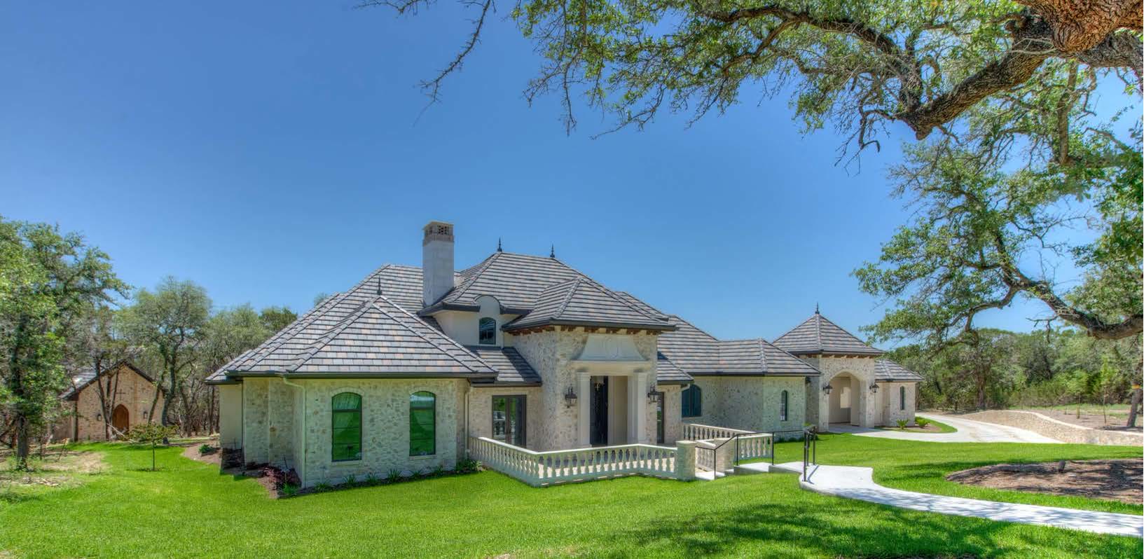 French Country Hill Country estate with a clay and concrete tile roof and private chapel