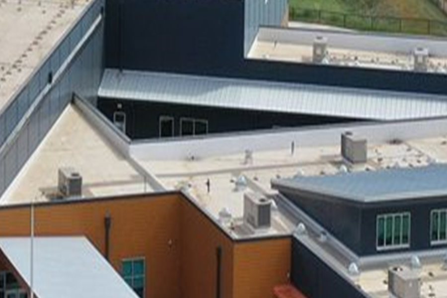 Standing-seam metal roof over a school entrance canopy