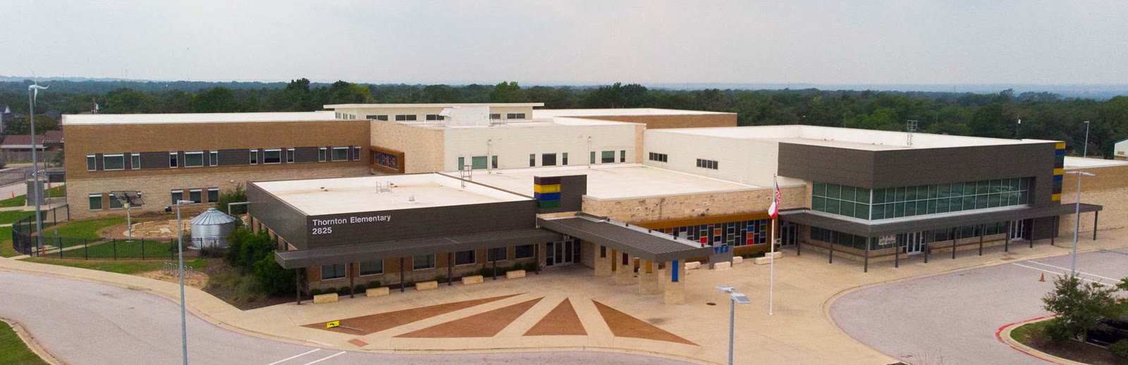 Entry canopy at Thornton Elementary with its name sign visible